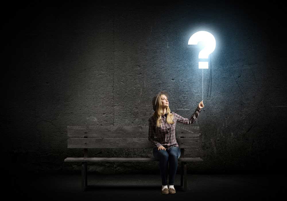 image of a girl holding a question mark sign in the air - addiction versus dependence - is there a difference? Summit BHC addiction treatment centers and drug addiction detox centers in Louisiana Texas and California