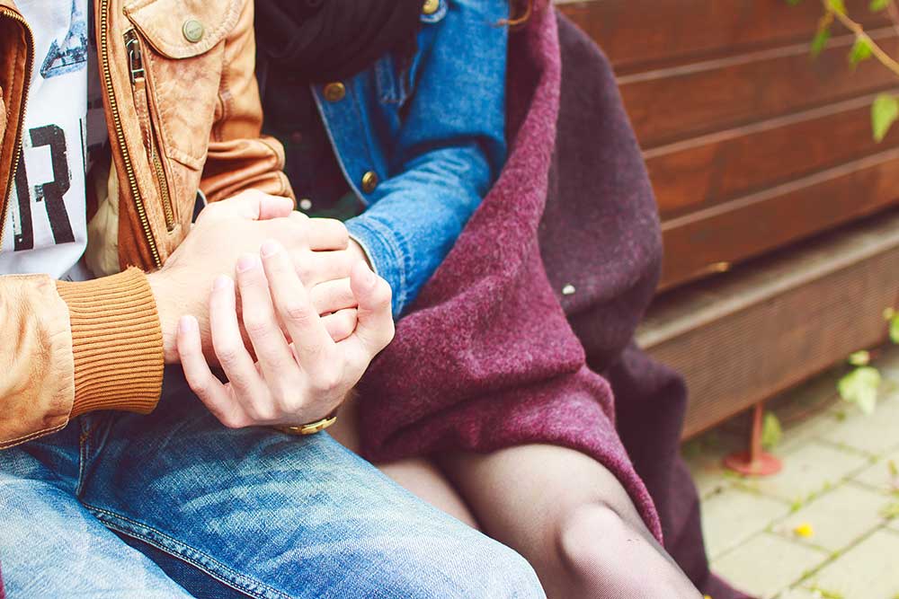 photo of two people clasping hands as they hold each other - acceptance of drug addiction - summit bhc - addiction treatment centers nationwide - drug rehab drug detox 