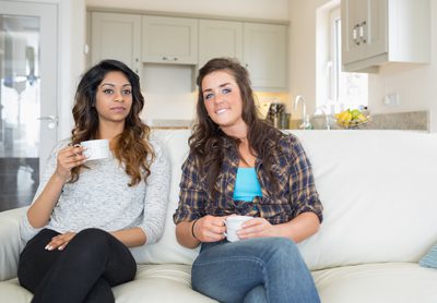 sober living environment like - two girls sitting on a sofa - summit bhc