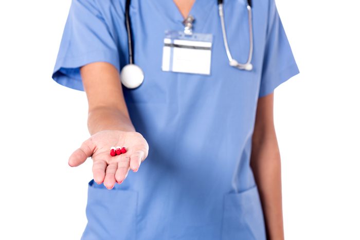 Nurses and Substance Abuse: How Access can Lead to Addiction - nurse holding a pill
